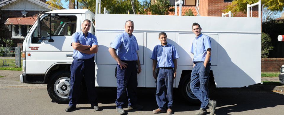 four of our Concord plumbers standing ready by their truck